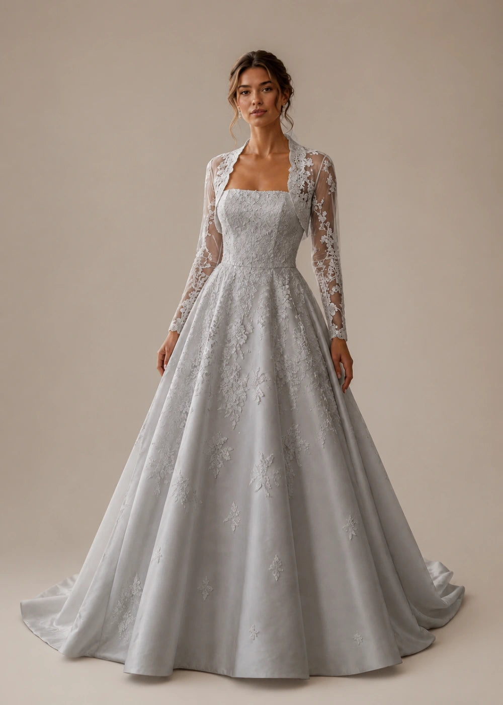 Front view of the silver gray square-neck A-line gown with a long-sleeve lace bolero-style overlay