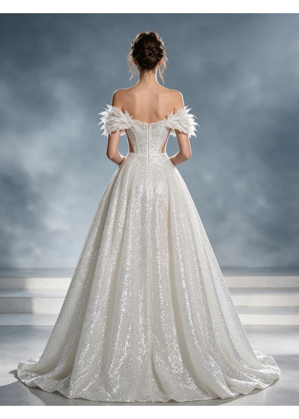 Back view of the white sequin gown showing the textured shoulder fringe and full train