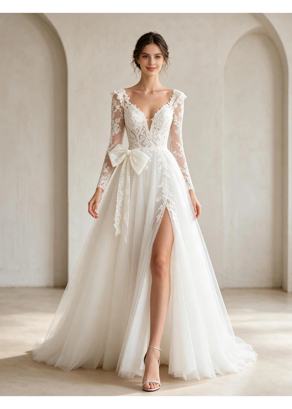 Front view of a white V-neck lace A-line gown with a large waist bow and open front slit